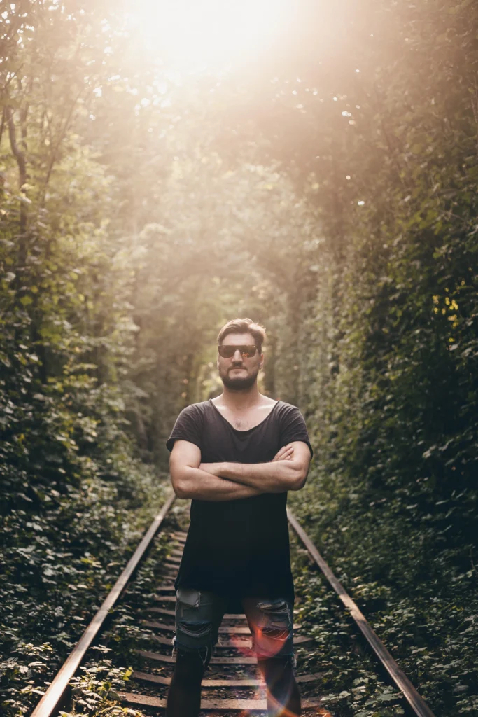 young guy with beard posing street sunset